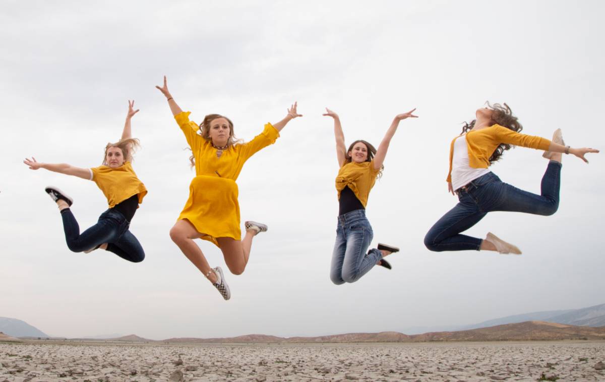 Four girls jumping in dance poses