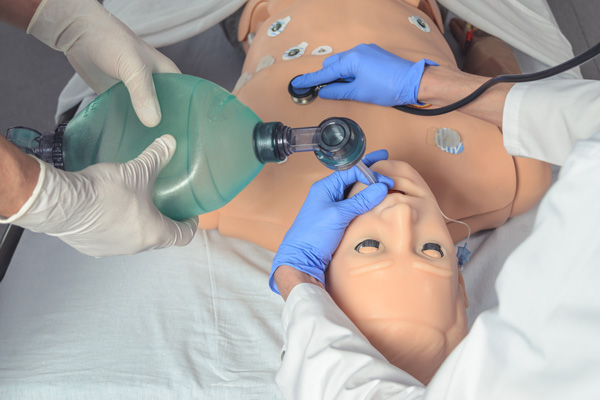 Students practicing an endotracheal intubation on a medical dummy.